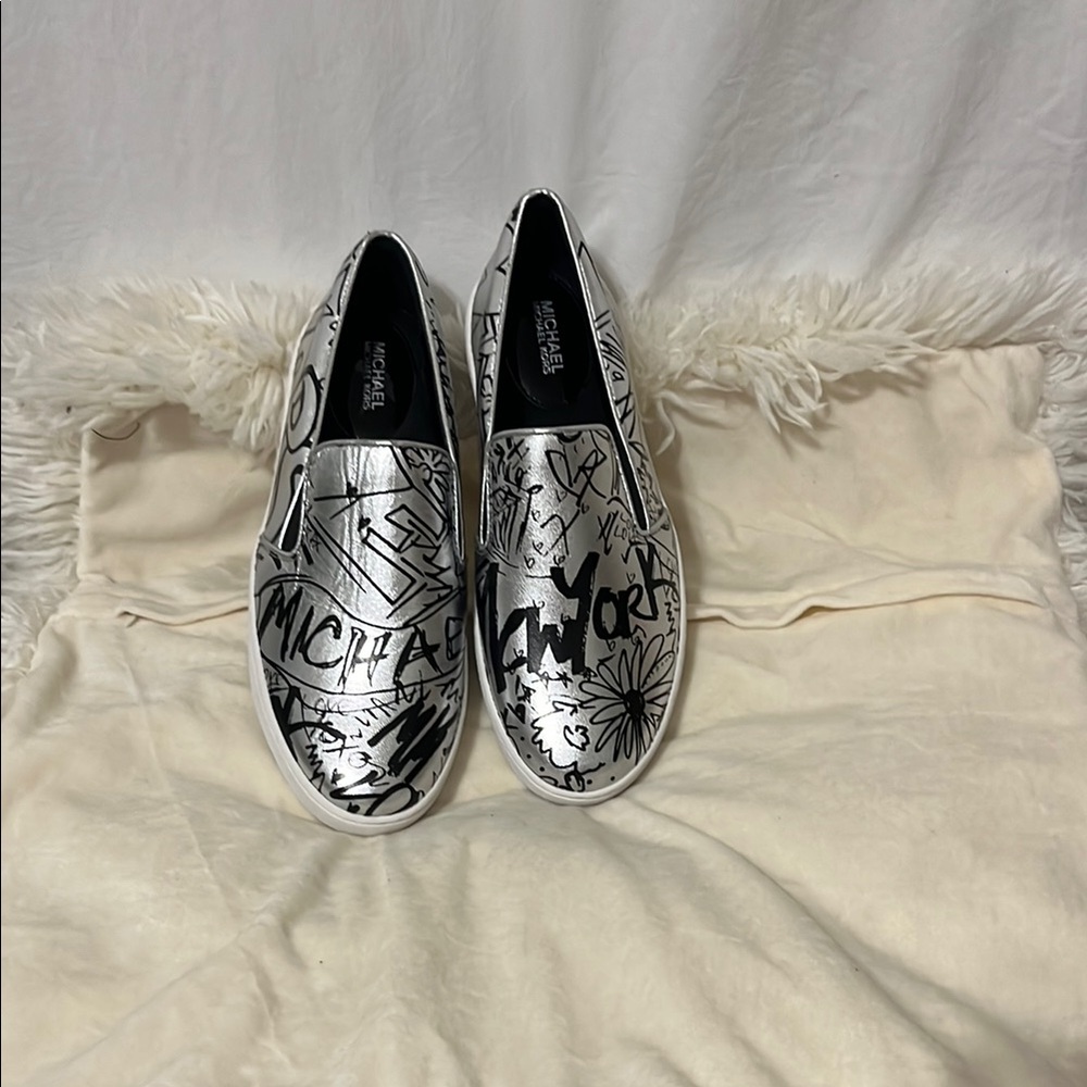 This New Michael Kors Metallic Slip-On Shoes with Black Design
